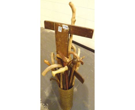 Brass stick stand containing a quantity of walking sticks