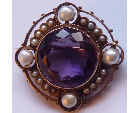 A late-19th century circular yellow metal Brooch centrally set with a pale hand-cut amethyst and surrounded by a border of pe
