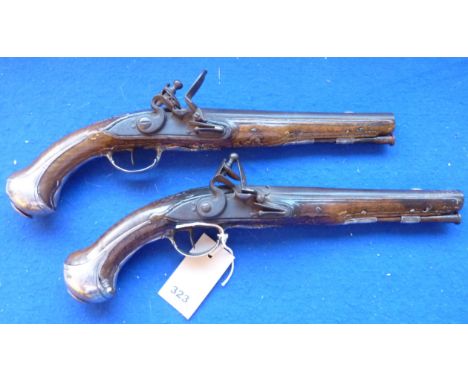 A pair of late 18th century French duelling pistols, 22cm barrels, approx. 13 bore, engraved silver furniture and full-length