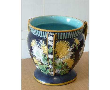 ADDED LOT    A large 19th century three-handled Majolica Planter decorated in relief with chrysanthemums etc.; 36.5cm high   