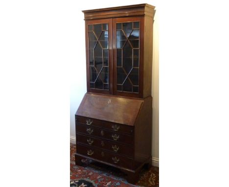 A George III period mahogany Bureau Bookcase, the cornice above two thirteen panelled doors with astragal glazing bars enclos