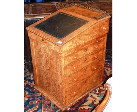 An unusual bird's eye maple early/mid 19th Century Davenport Desk, the three quarter gilt metal gallery sliding top above a l