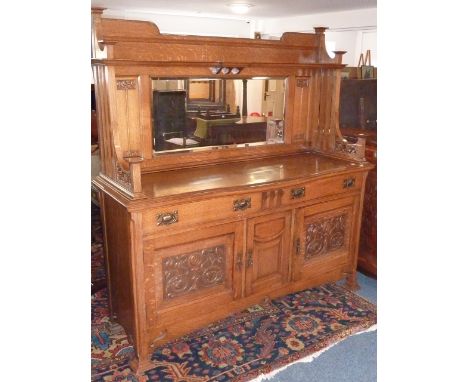 ADDED LOT    A fine early 20th century oak Dresser in Liberty's style, the mirrored superstructure with high shelf above a re