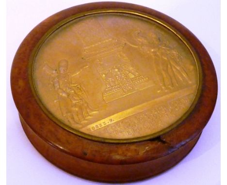 A French, 19th century, circular, wooden Table Snuff Box, the convex 'glass' covering a Classical style gilt-metal plaque dep