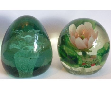 A 19th century green glass Dump (9cm), together with one other similar sized Paperweight internally decorated with a flower i