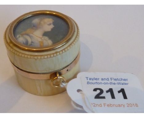 An early 19th century gold-mounted circular ivory Patch Box inset with a portrait miniature 