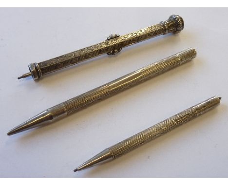 Three hallmarked silver Propelling Pencils, one with an unengraved amethyst seal top