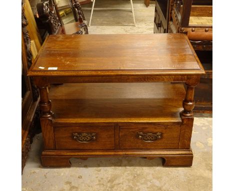 An oak 2-tier stand, with turned columns and drawers to the base, on bracket feet, W76cm, H54cm, D45cm 