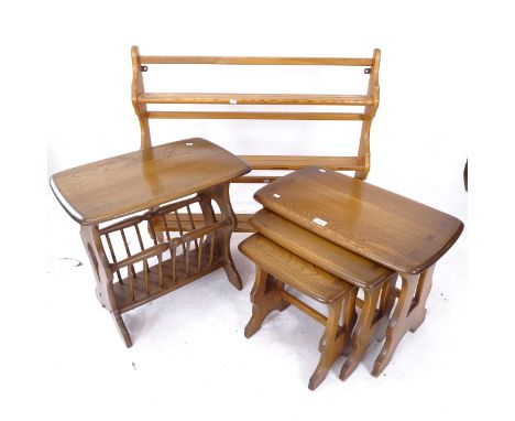 An Ercol elm nest of 3 occasional tables, an Ercol magazine rack, and a hanging shelf (3) 