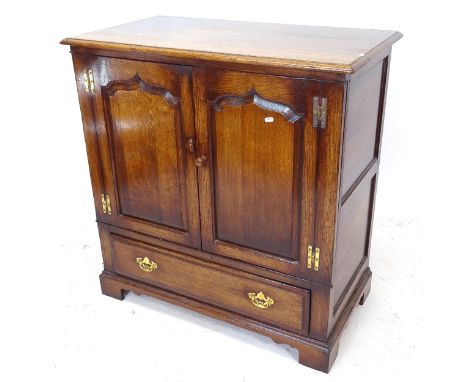 A Titchmarsh & Goodwin joined oak side cabinet, with fielded panelled doors, on bracket feet, W93cm, H96cm, D51cm 