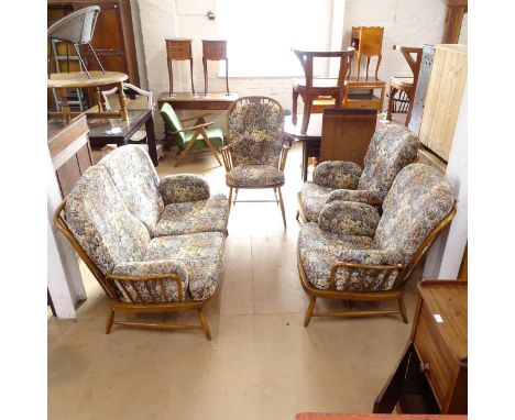 An Ercol stick-back 3-piece lounge suite, comprising a 2-seater settee and a pair of matching armchairs, together with an Erc