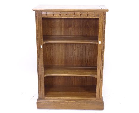 An Ercol elm open bookcase, with adjustable shelves, W64cm, H97cm, D33cm 