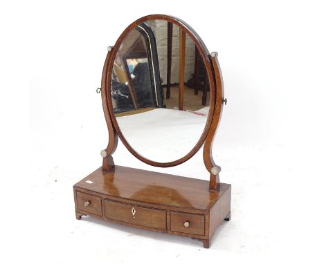 An early 20th century mahogany oval swing toilet mirror, W43cm, H62cm, D20cm 