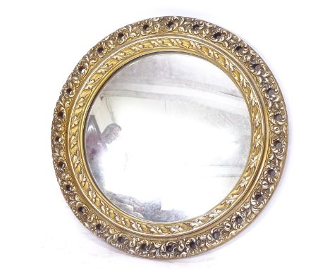 A circular mirror, in a pierced gilt-gesso frame 