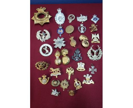 Box containing a quantity of various military cap badges, mostly staybright, for various regiments including Scottish, Cavalr