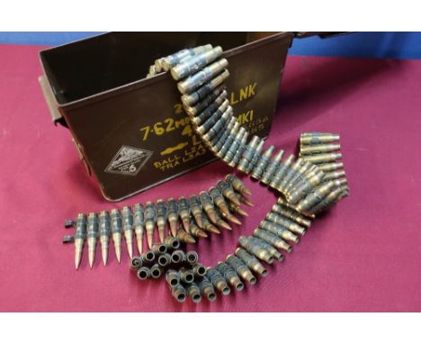 7.62mm ammunition tin with a belt of inert 7.62 casings, some with heads 