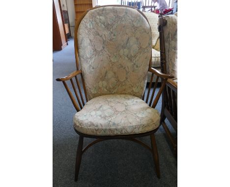 An Ercol stained beech stick-back Windsor chair, with crinoline stretcher and floral loose cushions