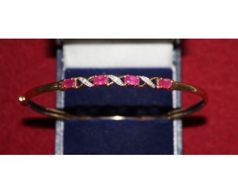 A 9ct gold ruby and diamond set bangle, 4gms