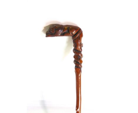 Carved walking stick the handle in the form of a recumbent lion with coled snake, 82cm long