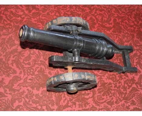 Scale model cast iron canon on wheeled stand, 30cm high x 70cm long