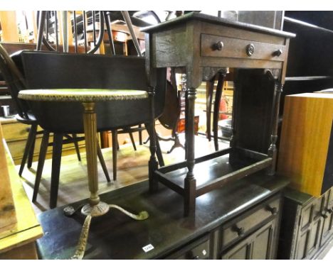 A dark Ercol elm and beechwood cottage drop leaf dining table together with a set of four hoop and stick back chairs, one oth