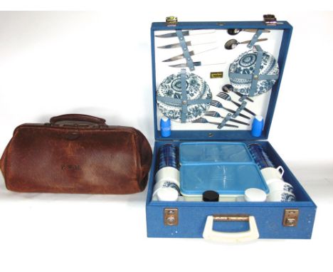 Vintage cased picnic hamper by Brexton to include ceramic plates, cups, etc; together with a vintage leather Gladstone bag (2