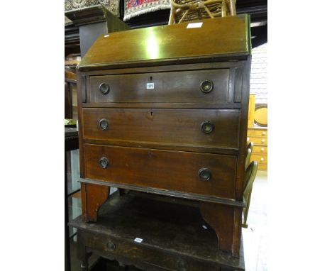An inlaid Edwardian mahogany bureau with chequered stringing, the fall flap with oval musical instruement marquetry panel enc