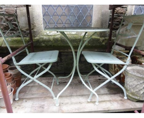 A contemporary light steel framed three piece terrace set comprising table of circular form with pierced foliate detail and a