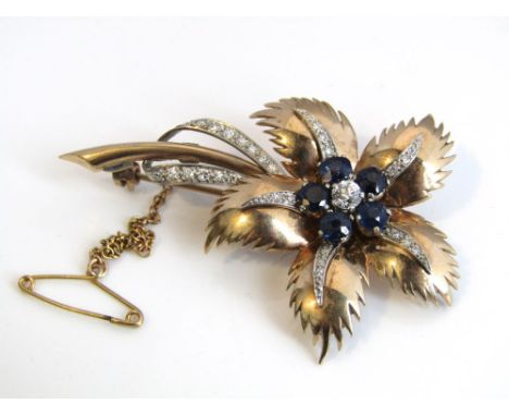 An early 20th century unmarked yellow and white metal diamond and sapphire flower brooch, set with central old brilliant cut 