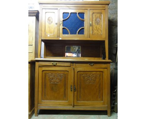 An early 20th century continental walnut and stained beechwood buffet, the lower section enclosed by a pair of moulded panell