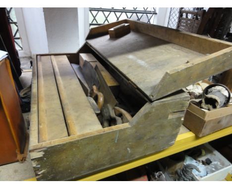 A wooden portable tool chest containing a quantity of vintage carpentry hand tools
