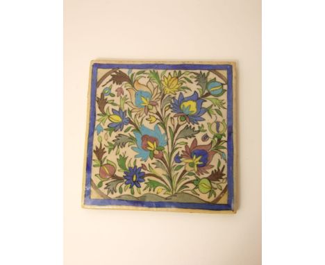 A ceramic tile in the Iznik manner with polychrome painted floral and leaf detail, 24cm square approx