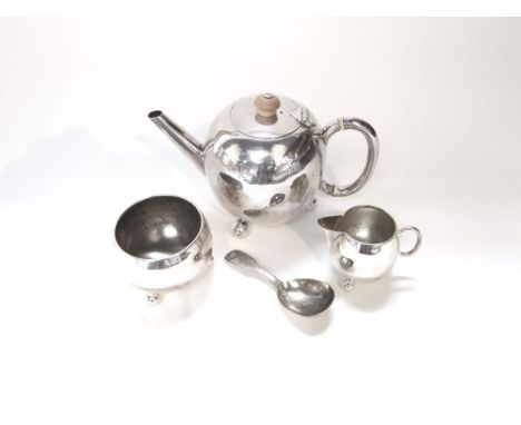 A three piece silver tea set, the bullet shaped teapot accompanied by a sugar basin and cream jug, London 1888, together with