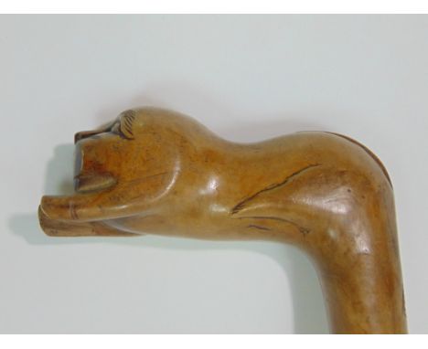 Early primitive carved Grecian walking stick, the handle in the form of a recumbent lion, 78cm long