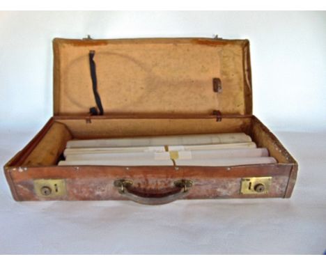 A leather case containing a large collection of architectural drawings