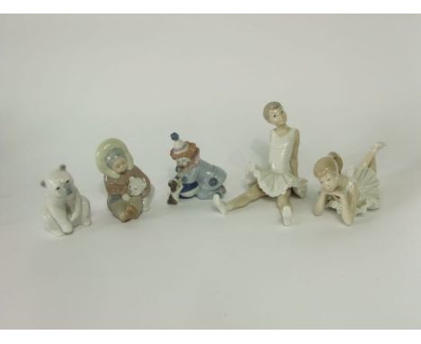 A collection of Lladro and Nao groups comprising a pair of ballerinas, one seated and one lying down, an Inuit child cuddling