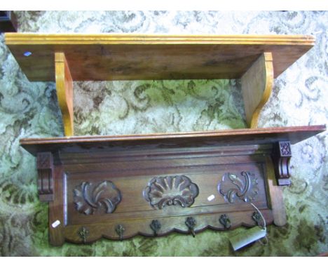 An elm wall shelf with shaped brackets together with a further oak hall shelf with carved details and applied brass hooks