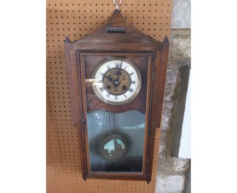 Arts and craft drop dial wall clock, with two train enamel chapter ring and pendulum decorated in relief with a castle scene