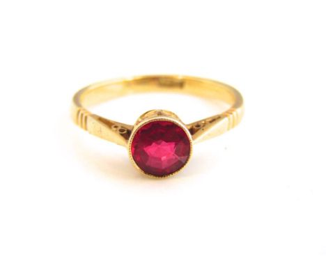 A ladies 18k gold and synthetic ruby ring, central round cut ruby in openwork colette set rub over mount, 2.8g, ring size 'N'