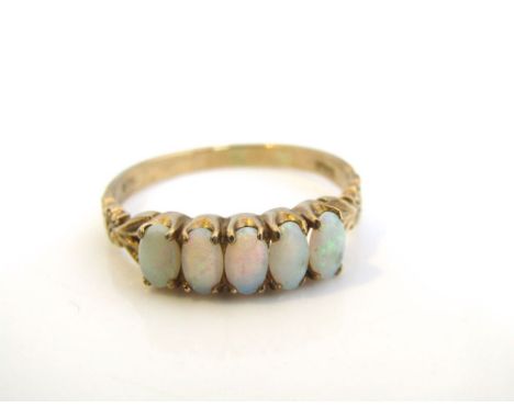 A 9ct gold five stone opal ring with engraved and decorated shoulders, ring size R, 2.3 g