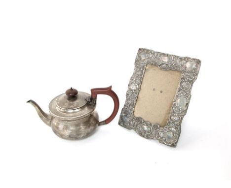 A sterling silver bachelors teapot 10 oz, Birmingham 1925, together with a silver plated ornate rectangular picture frame