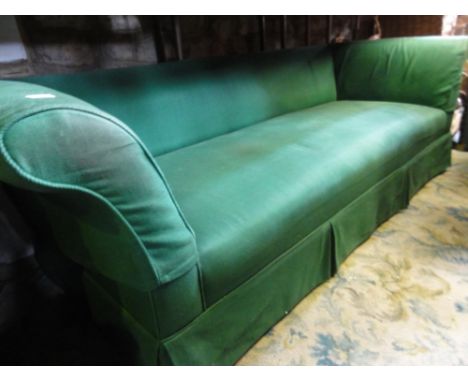 An early 19th century three seat sofa with swept and rolled arms and upholstered in a mint green fabric raised on turned, tap