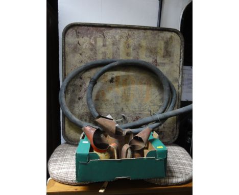 A vintage cast aluminium garage sign advertising Shell X-100 motor oil, together with a fuel pump hose stamped to fitting GT 