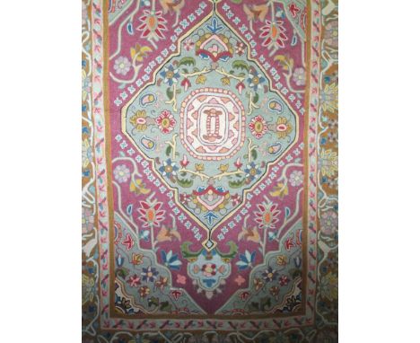 Silk work floor rug/wall hanging centrally decorated with a a large turquoise medallion upon an amethyst ground, 160 x 90cm 