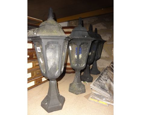 A set of four contemporary light cast metal exterior lanterns of tapered hexagonal form with glazed panels