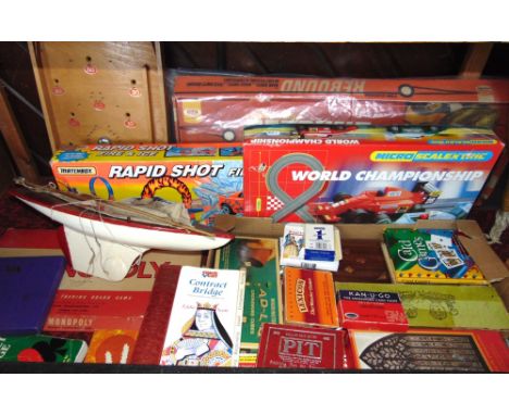 A box containing a collection of vintage toys to include Monopoly, Bagatail, Scalectrix, etc together with a vintage pond yac