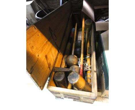 A vintage croquet set housed within its original pine box with side carrying handles