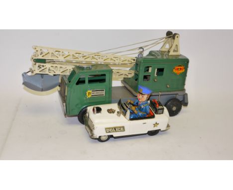 Vintage Tin Toys, A duo of toys comprising a boxed battery operated 'Mystery' Police Car (areas of rust) by TN Japan together