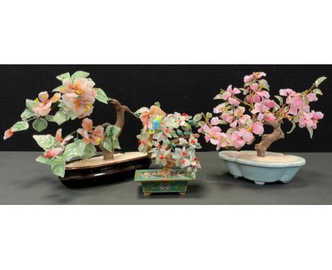A pair of Chinese enamel and silver birds, resting upon a gemstone and glass tree, mounted with pale and deep green fruit and