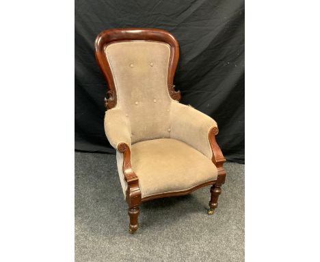 A Late Victorian mahogany library chair, carved hooped button back, upholstered in chocolate brown fabric, turned fore legs, 